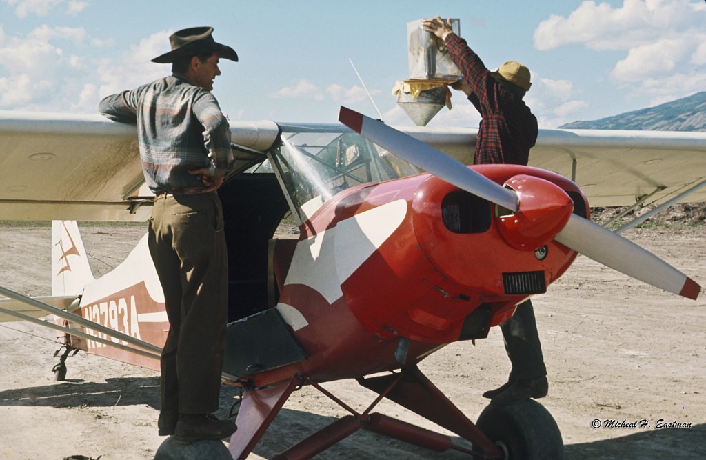Gordon Eastman watching his friend and bush pilot, Warren Johnston, filling the Super Cub up with gas. Notice he is straining the gas.